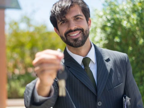 Real estate agent holding out house keys